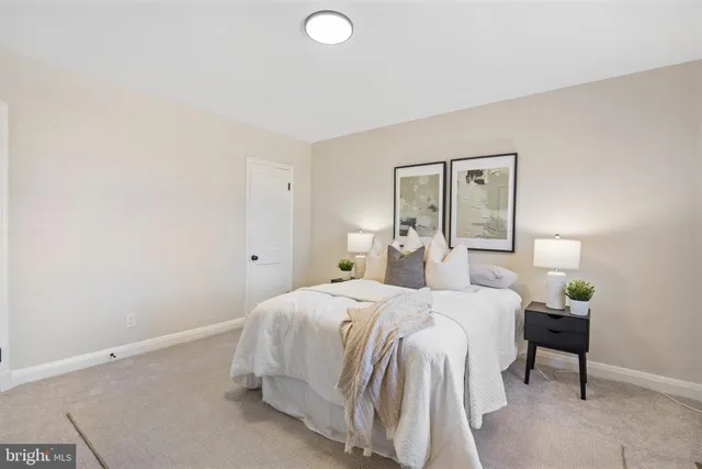 a bedroom with a bed and a potted plant