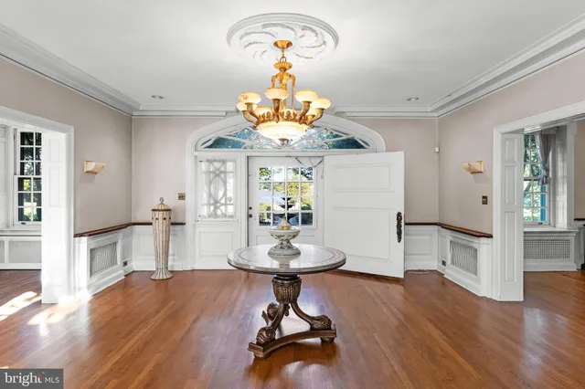 a living room with a fireplace and a floor to ceiling window
