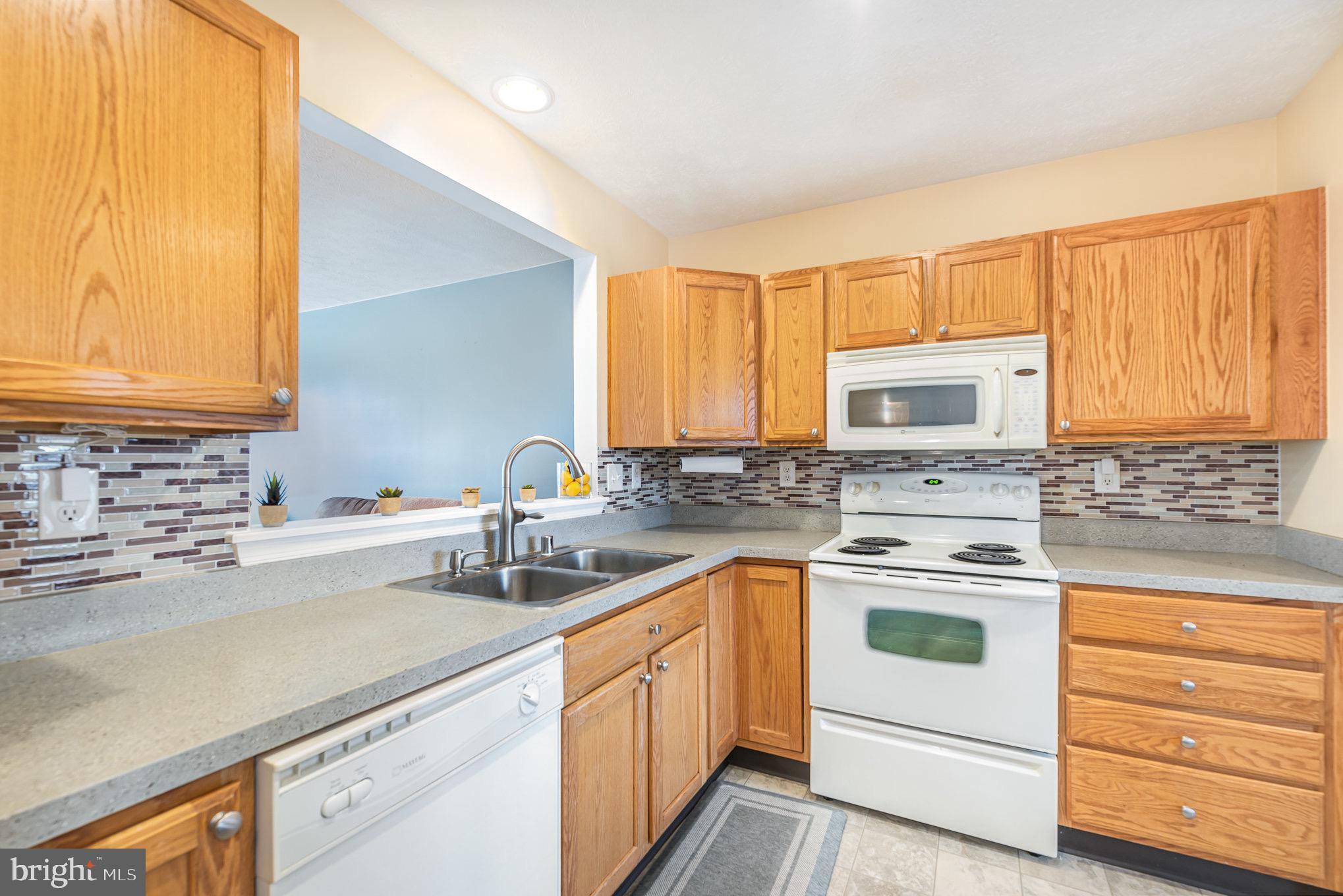 118 Maple Leaf Drive Rising Sun, MD 21911 - Photo 11 of 29 a kitchen with a sink stove top oven and cabinets