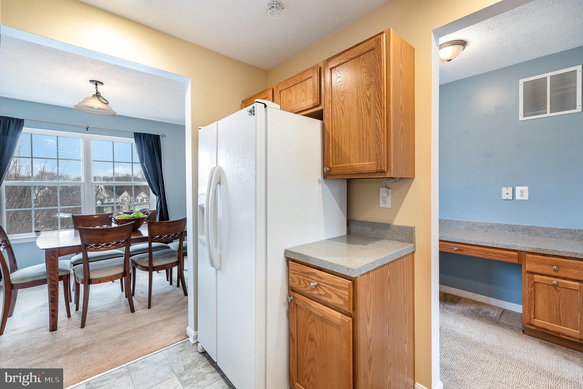 118 Maple Leaf Drive Rising Sun, MD 21911 - Photo 13 of 29 a kitchen with stainless steel appliances granite countertop a refrigerator and a stove top oven