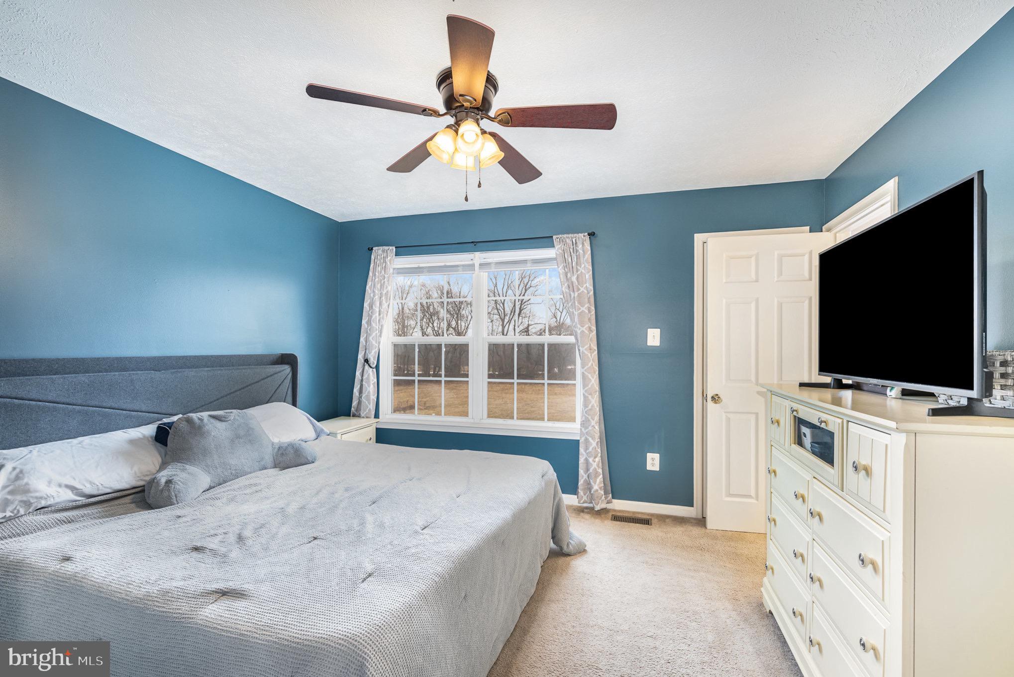 118 Maple Leaf Drive Rising Sun, MD 21911 - Photo 15 of 29 a bedroom with a bed and a flat screen tv