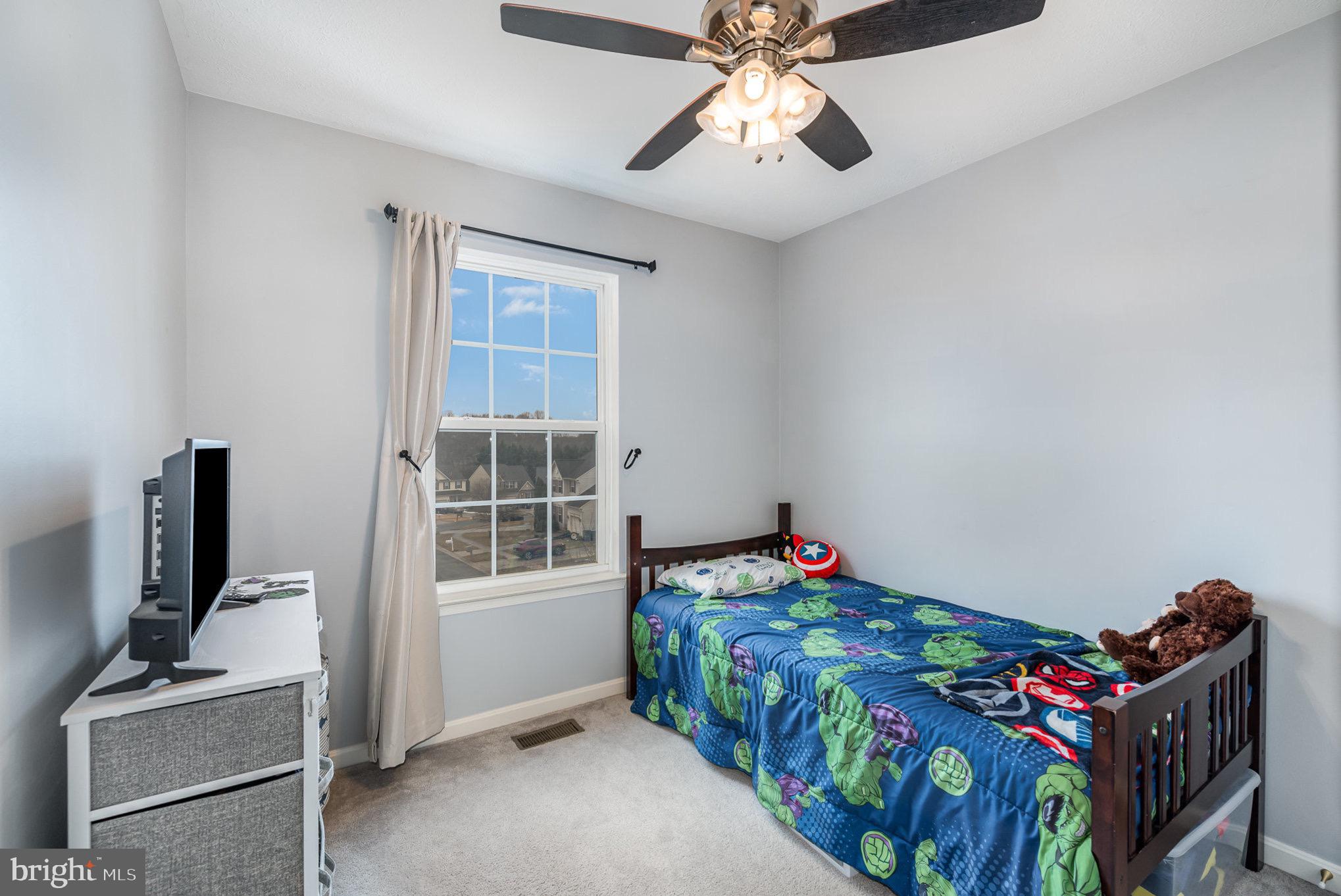 118 Maple Leaf Drive Rising Sun, MD 21911 - Photo 21 of 29 a bedroom with a bed and wooden floor