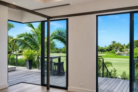 a view of a porch with a floor to ceiling window and wooden floor