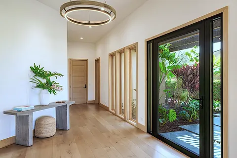 a very nice looking room with a large window and wooden floor