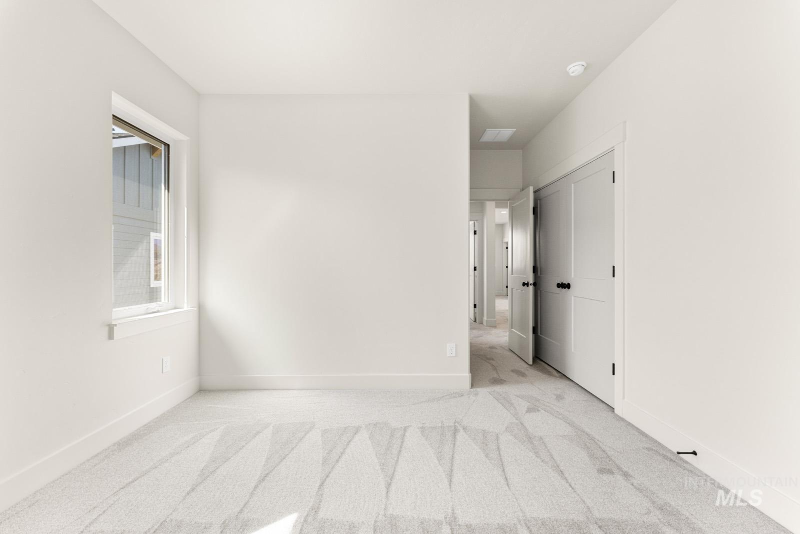 13344 North Spring Creek Way Boise, ID 83714 - Photo 24 of 39 Empty room with light colored carpet and baseboards