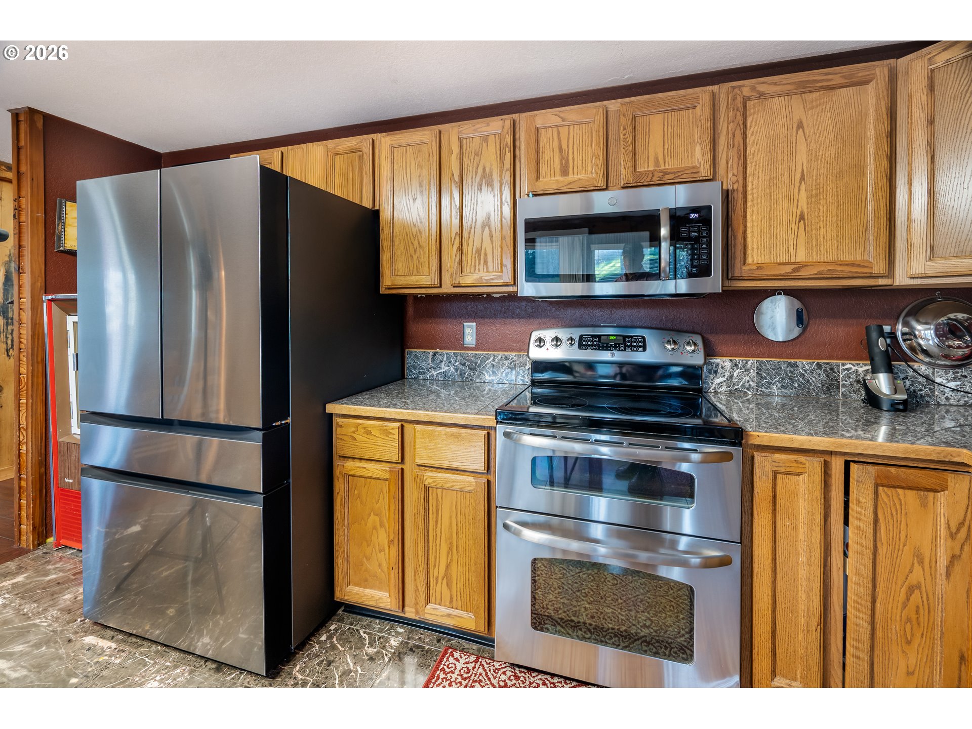 5278 Pearson Road Southeast Turner, OR 97392 - Photo 25 of 48 a kitchen with stainless steel appliances granite countertop a refrigerator sink and cabinets