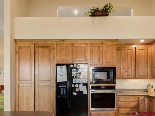 a kitchen with stainless steel appliances a refrigerator a stove a microwave and cabinets