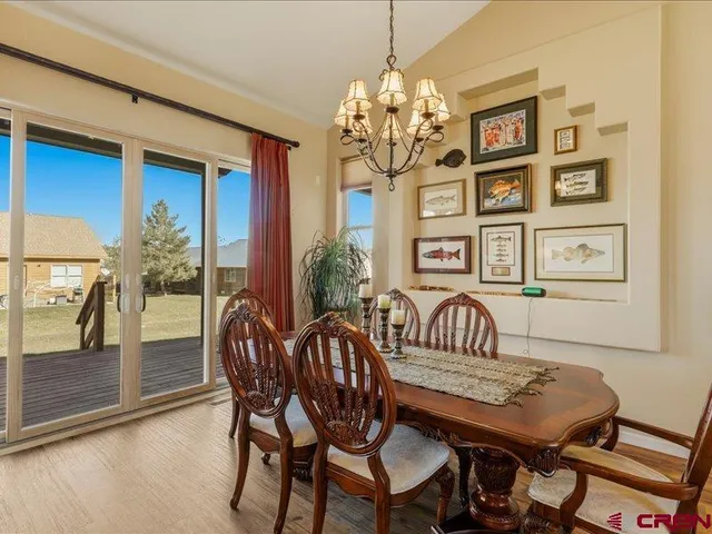 a view of a dining room with furniture wooden floor and chandelier