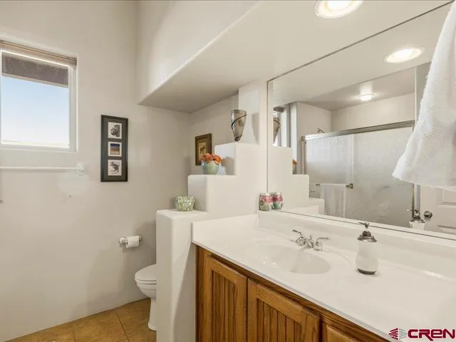 a bathroom with a sink toilet and mirror