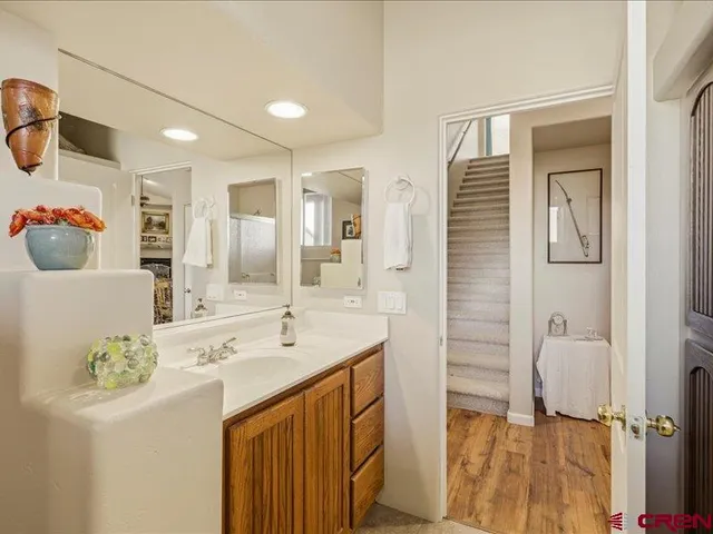 a bathroom with a sink vanity and mirror