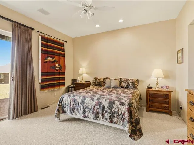 a bedroom with a bed and a lamp on table