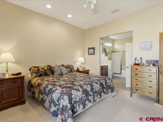 a bedroom with a bed and a night stand