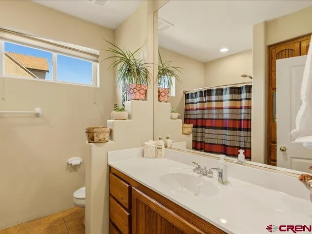 a bathroom with a sink vanity granite and a mirror