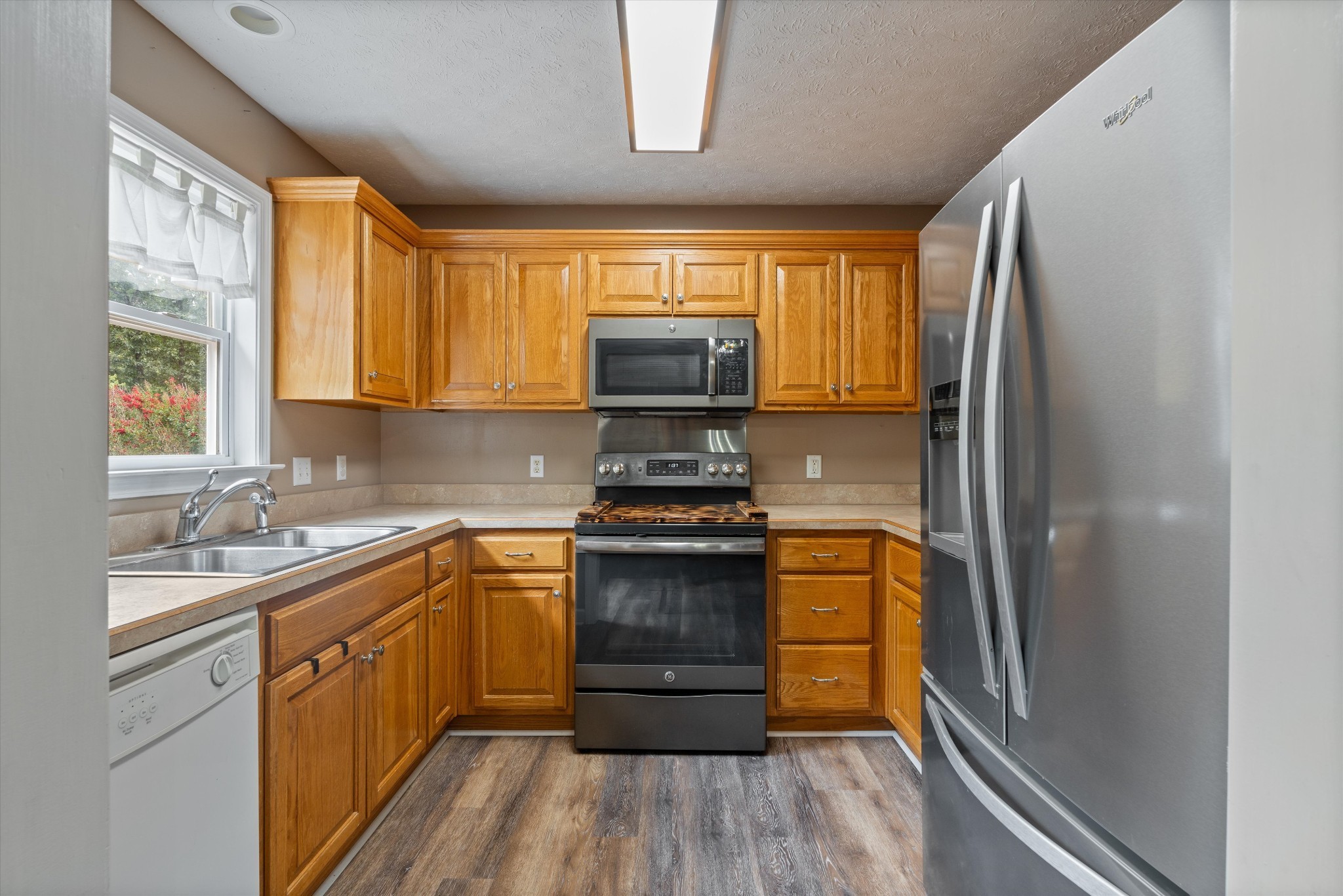 486 Sylvis Road Dickson, TN 37055 - Photo 11 of 24 a kitchen with a stove a sink and a refrigerator