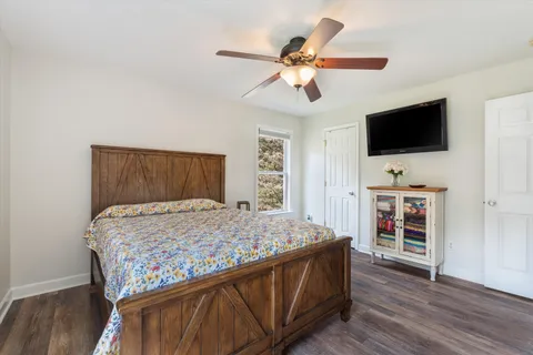 a bedroom with a bed and a flat screen tv