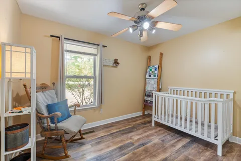 a view of a livingroom with furniture and a chandelier fan