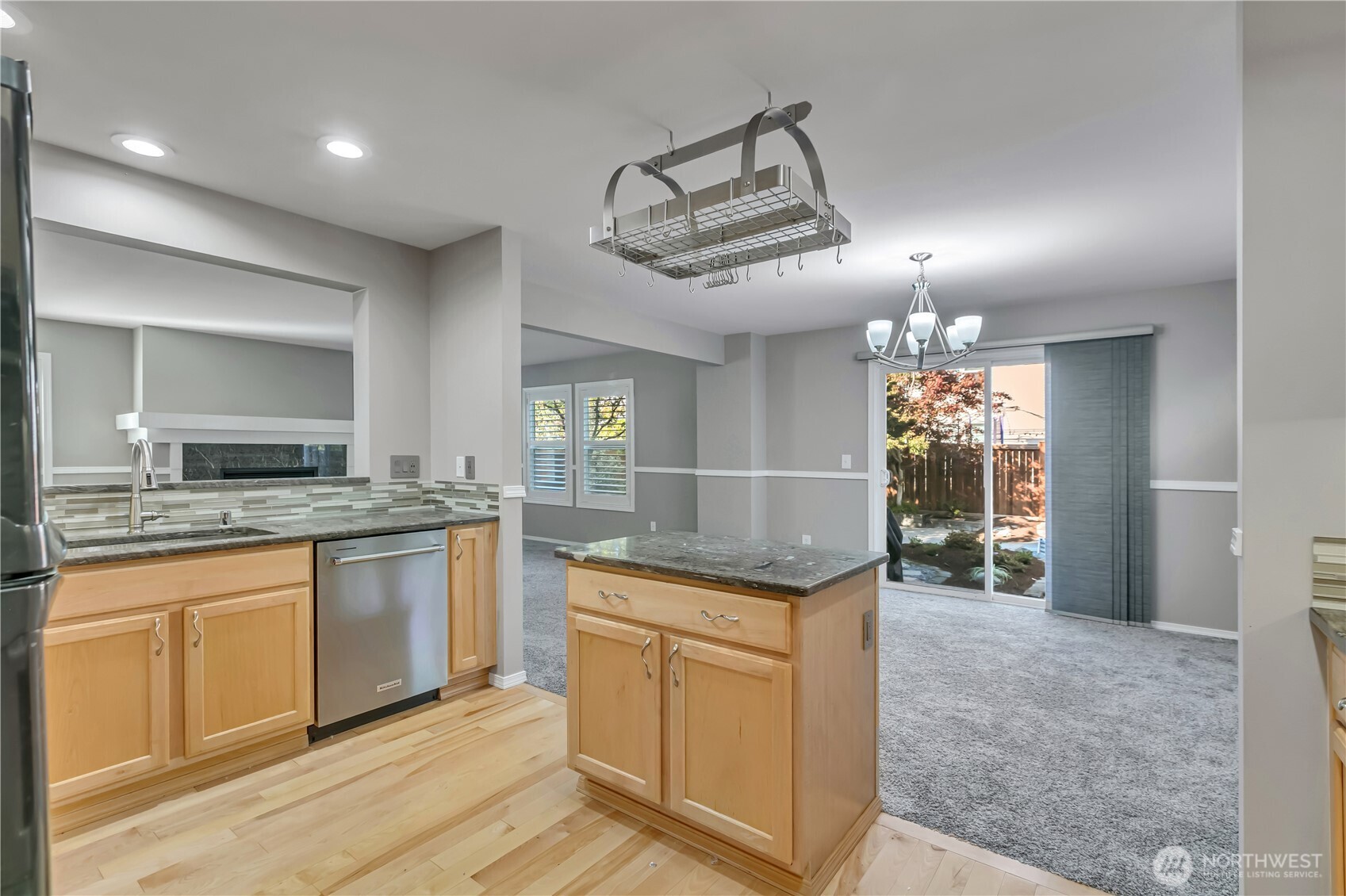 23516 Southeast 243rd Place Maple Valley, WA 98038 - Photo 13 of 31 a kitchen with kitchen island granite countertop a sink and stove