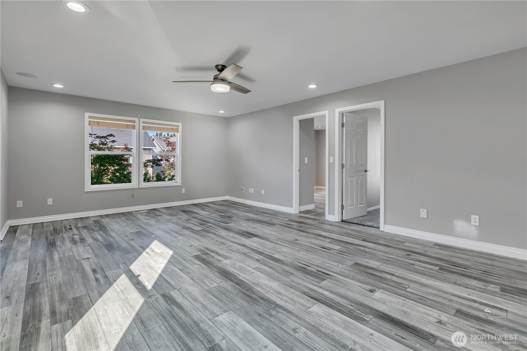 23516 Southeast 243rd Place Maple Valley, WA 98038 - Photo 18 of 33 a view of an empty room with wooden floor and a window