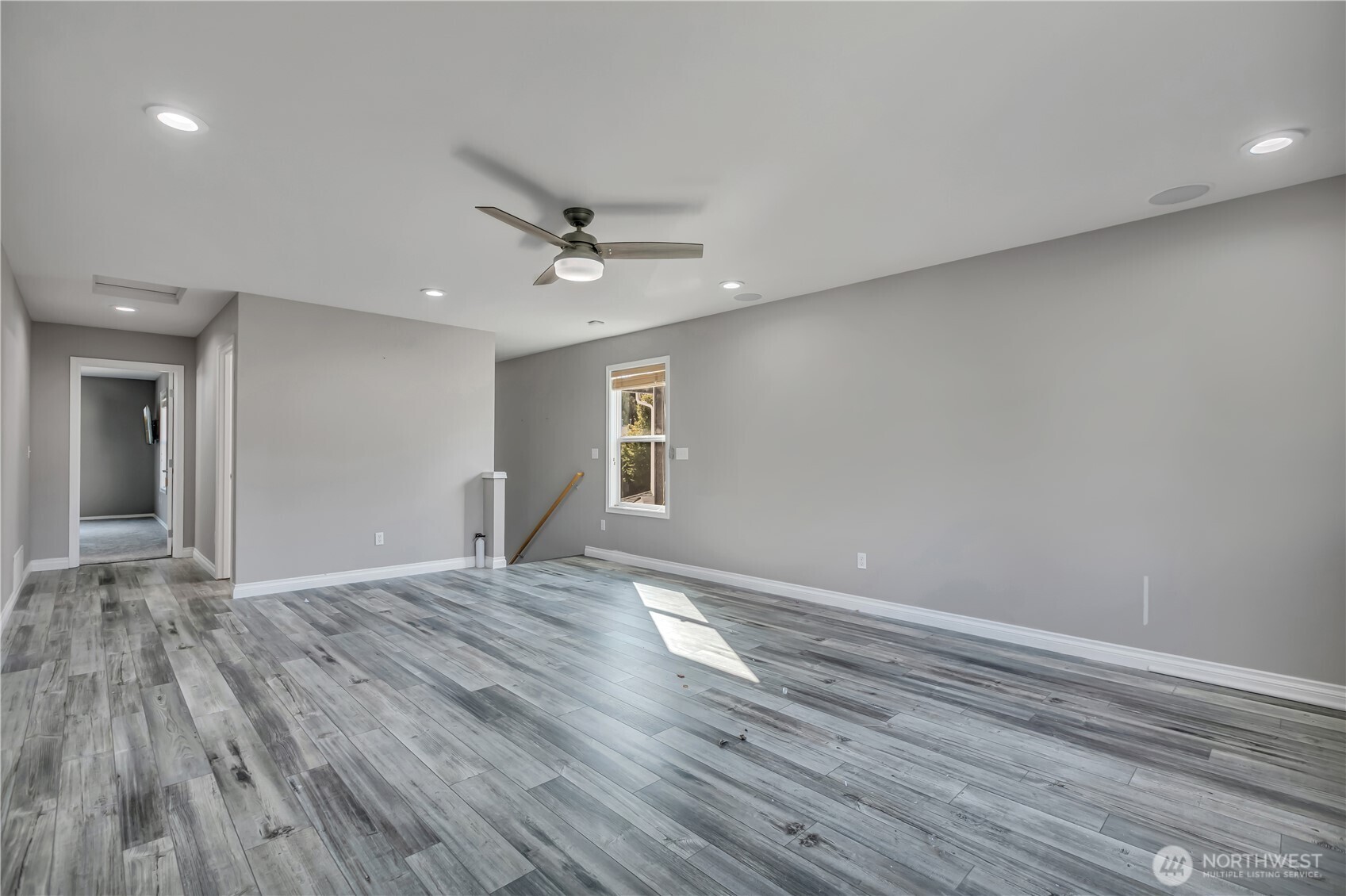 23516 Southeast 243rd Place Maple Valley, WA 98038 - Photo 20 of 33 a view of an empty room with window and wooden floor
