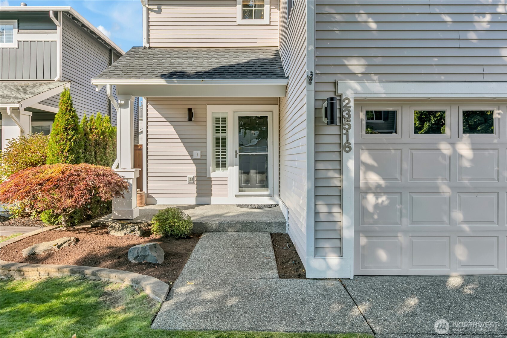 23516 Southeast 243rd Place Maple Valley, WA 98038 - Photo 2 of 33 a front view of a house with a yard