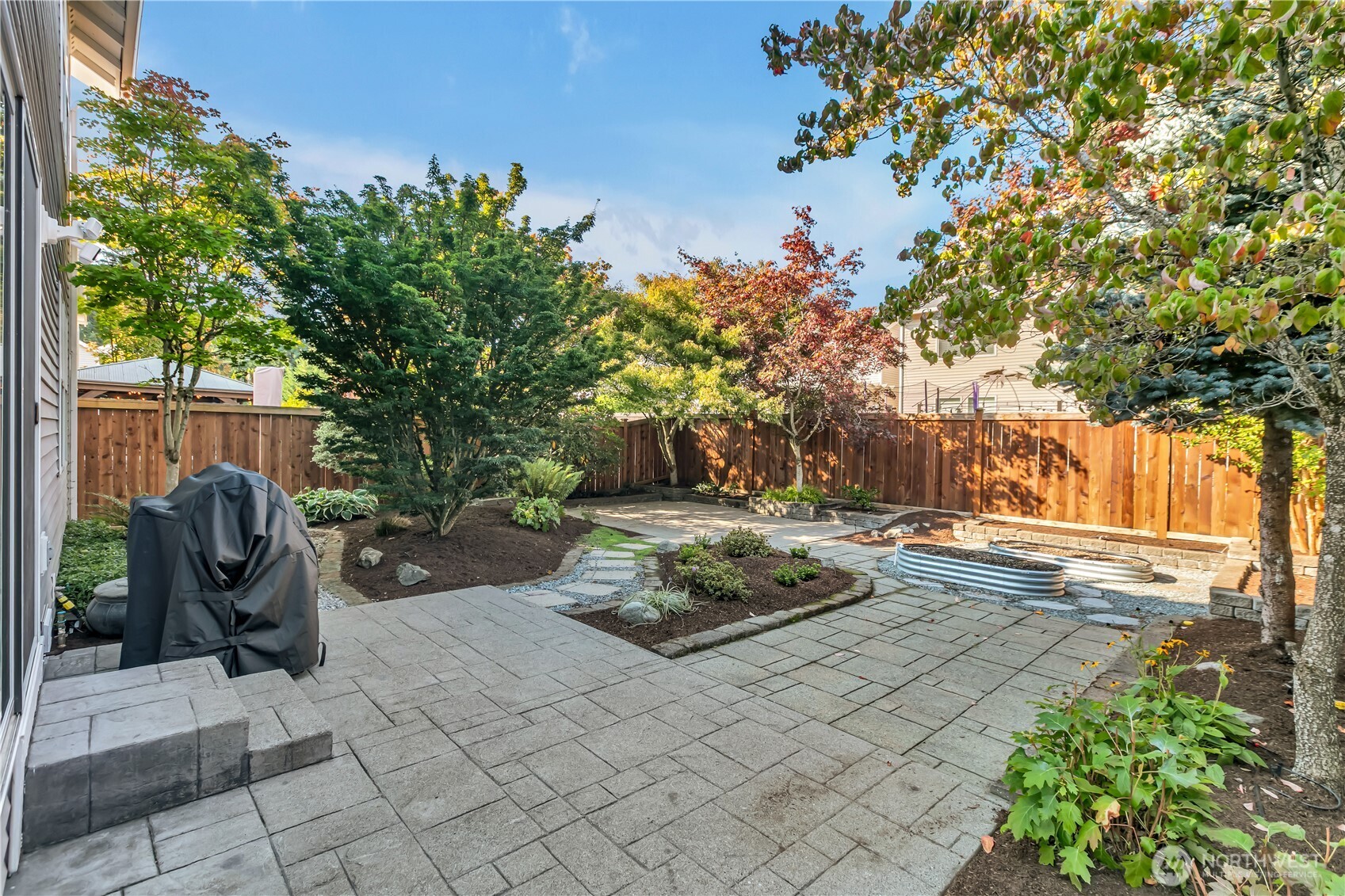 23516 Southeast 243rd Place Maple Valley, WA 98038 - Photo 29 of 33 a backyard of a house with table and chairs