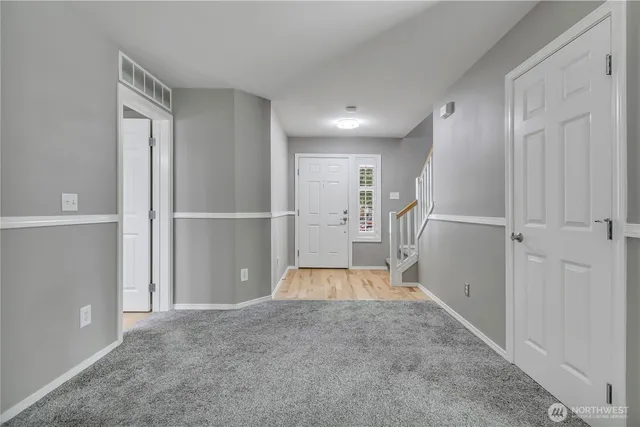 a view of entryway with wooden floor and door