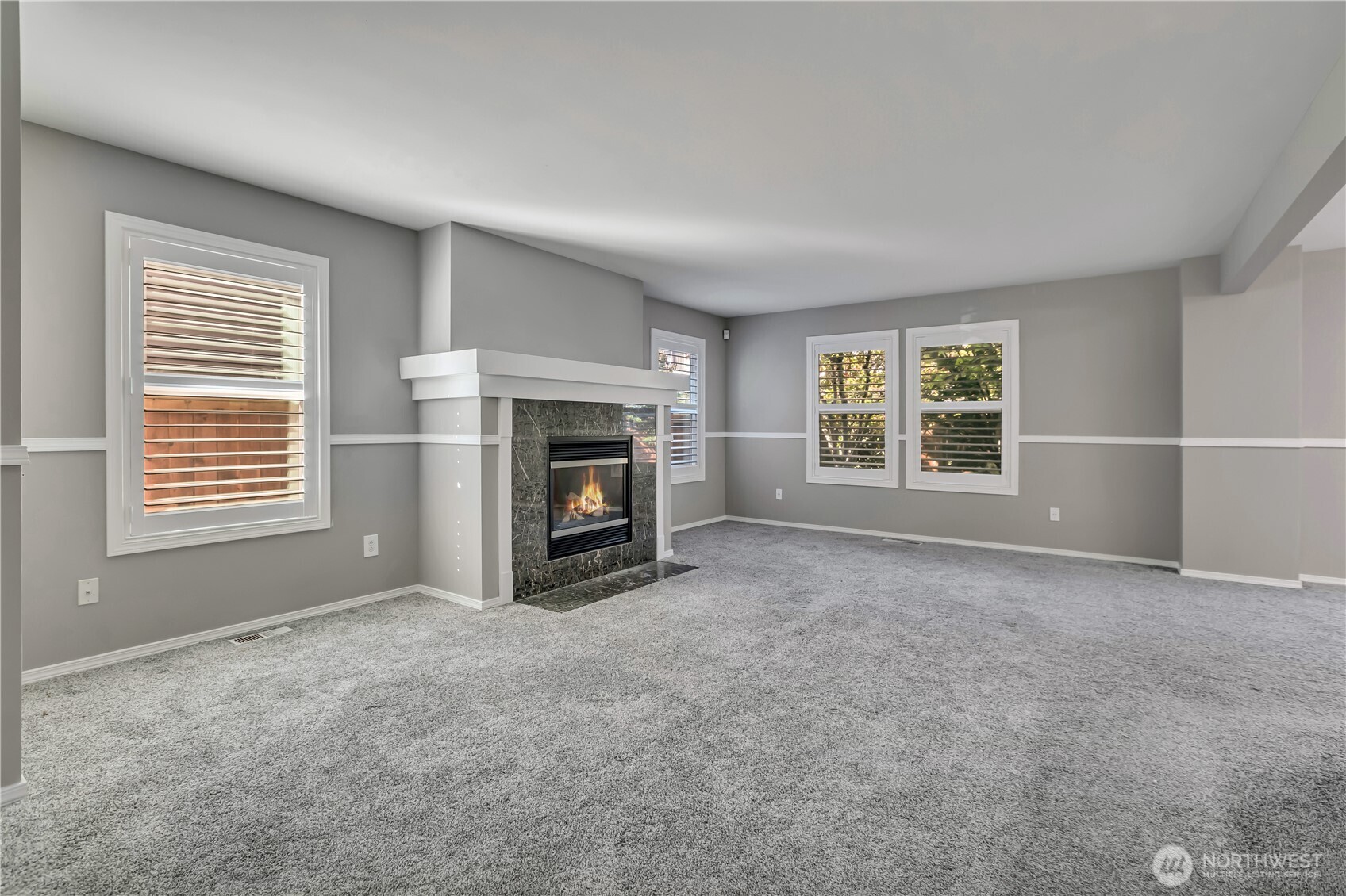 23516 Southeast 243rd Place Maple Valley, WA 98038 - Photo 5 of 33 an empty room with windows and fireplace