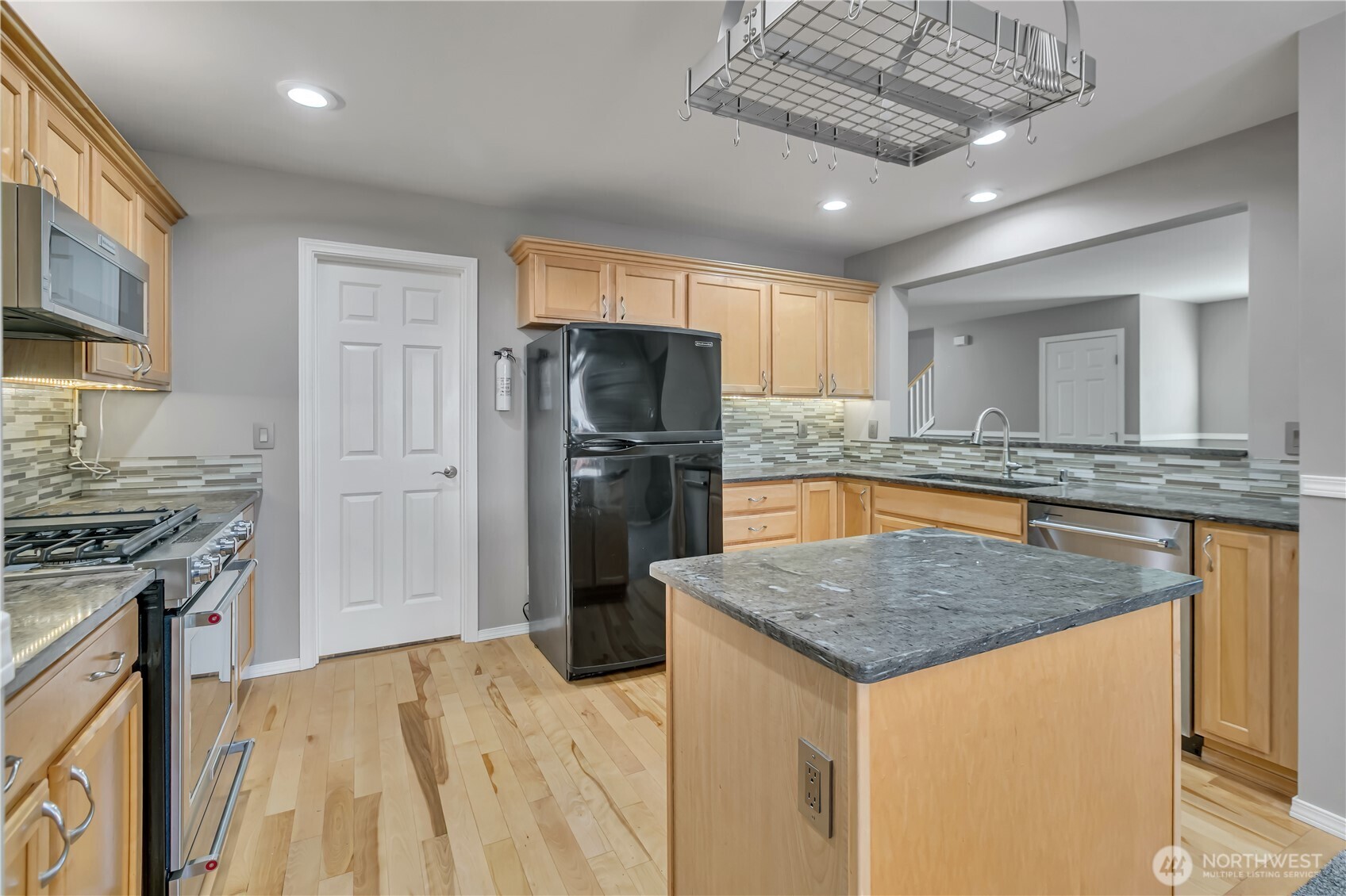 23516 Southeast 243rd Place Maple Valley, WA 98038 - Photo 10 of 31 a kitchen with stainless steel appliances granite countertop a sink stove and refrigerator