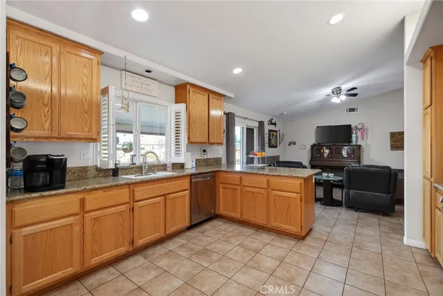 a large kitchen with stainless steel appliances granite countertop a sink and cabinets