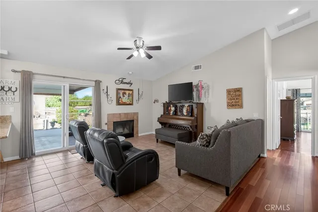a living room with furniture fireplace and flat screen tv