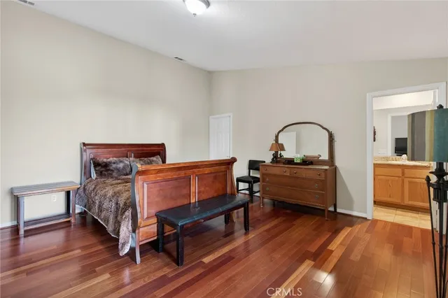 a bedroom with a bed and a dresser