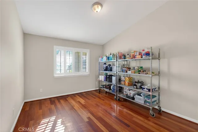 a room with lots of books and a window