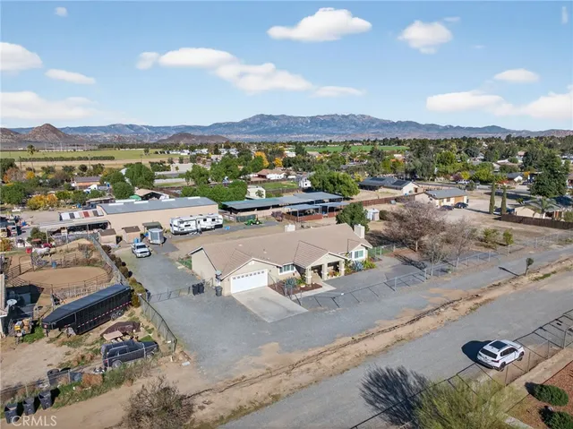 an aerial view of a house with outdoor space and ocean view