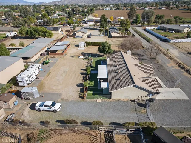 an aerial view of a house with a garden and lake view