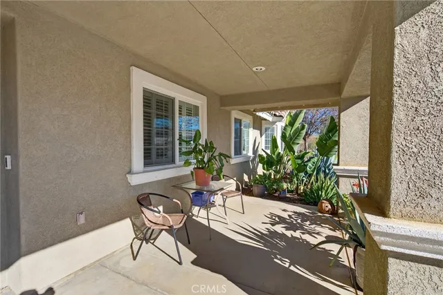 a balcony with chairs and a table