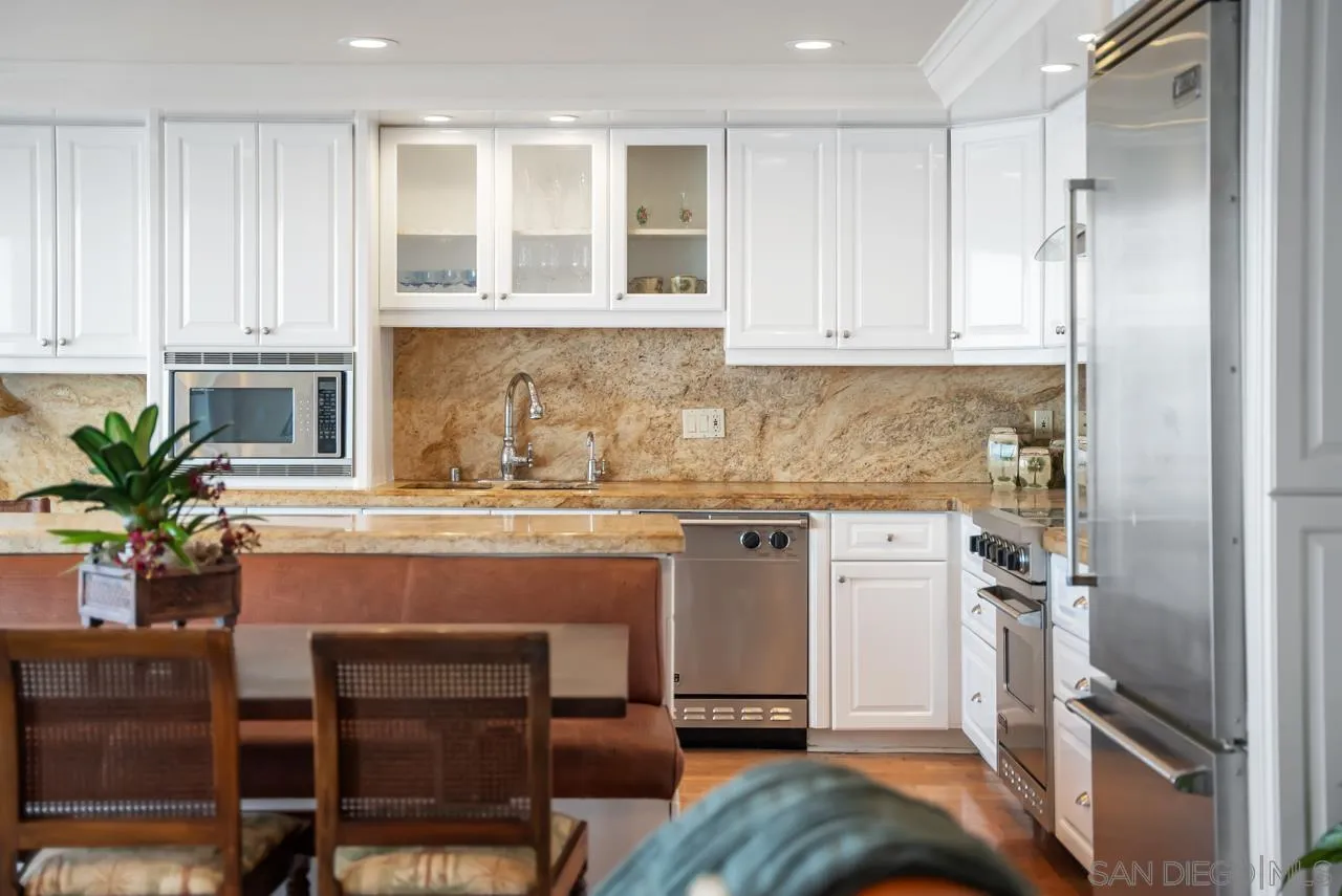 1219 Coast Boulevard, Unit 5 La Jolla, CA 92037 - Photo 12 of 31 a kitchen with stainless steel appliances granite countertop a refrigerator and a stove top oven