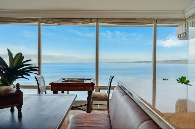 a living room with furniture and large windows