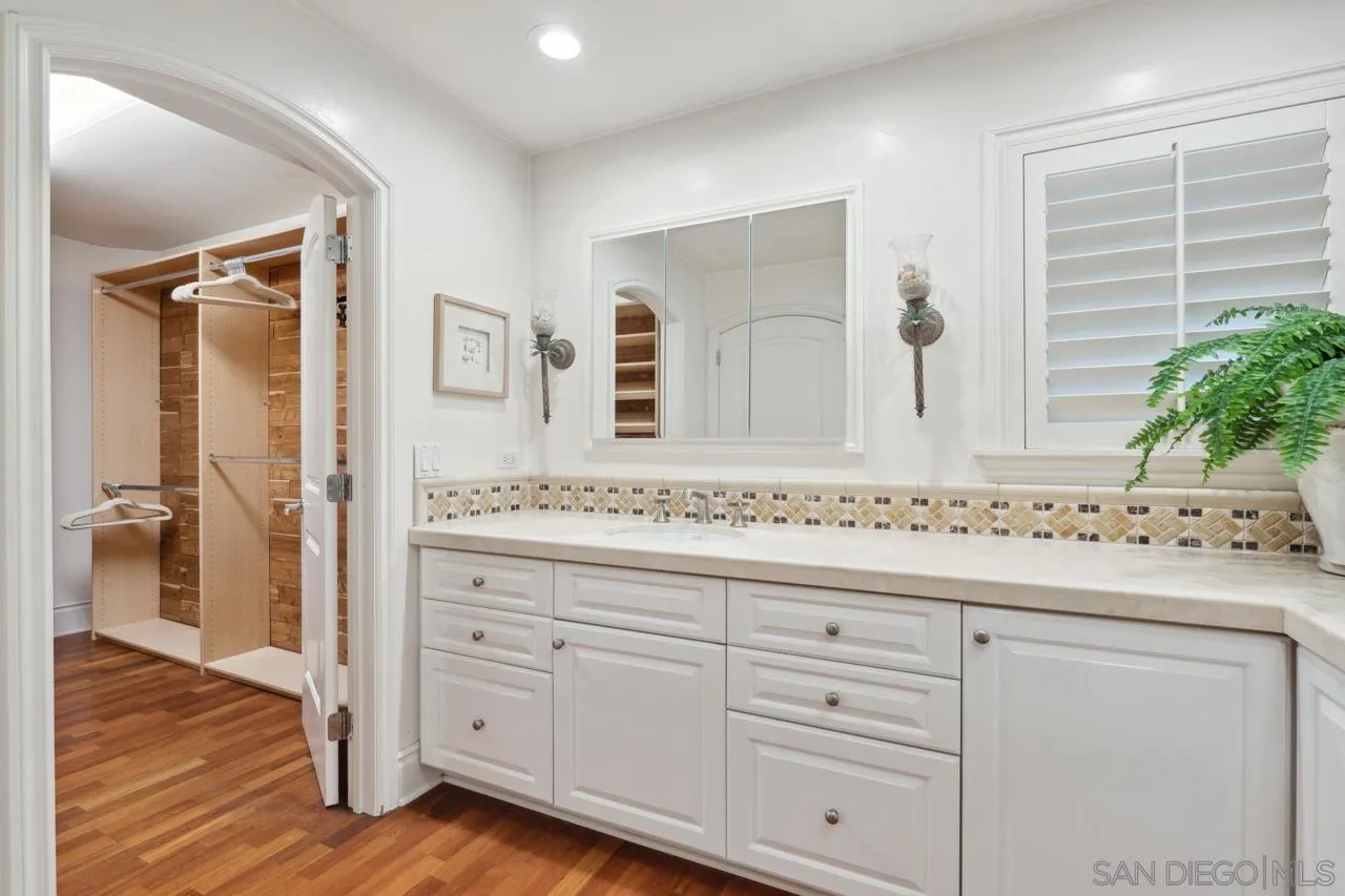 1219 Coast Boulevard, Unit 5 La Jolla, CA 92037 - Photo 22 of 31 a bathroom with a sink and a mirror