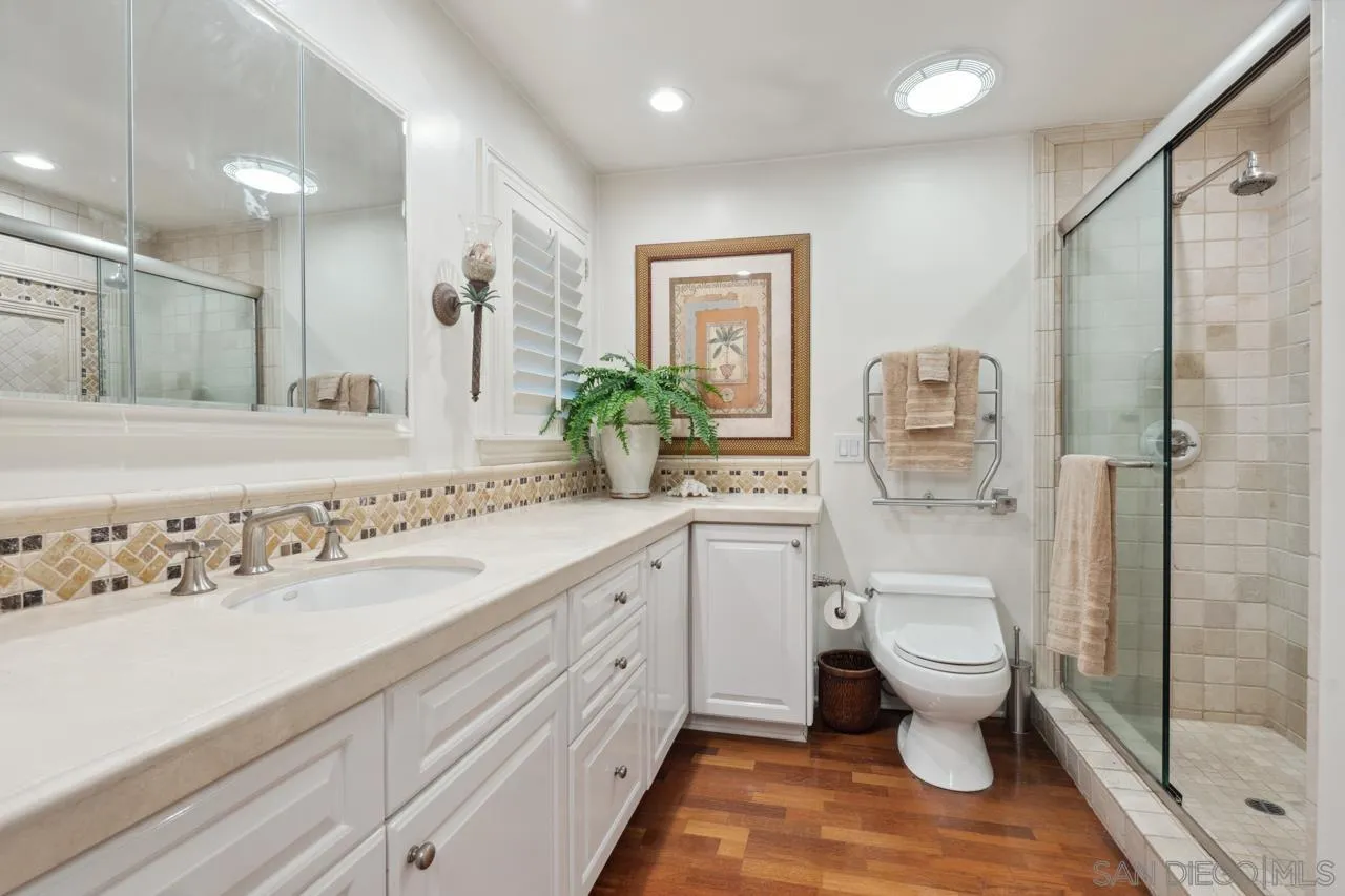 1219 Coast Boulevard, Unit 5 La Jolla, CA 92037 - Photo 24 of 31 a spacious bathroom with a granite countertop sink toilet and shower