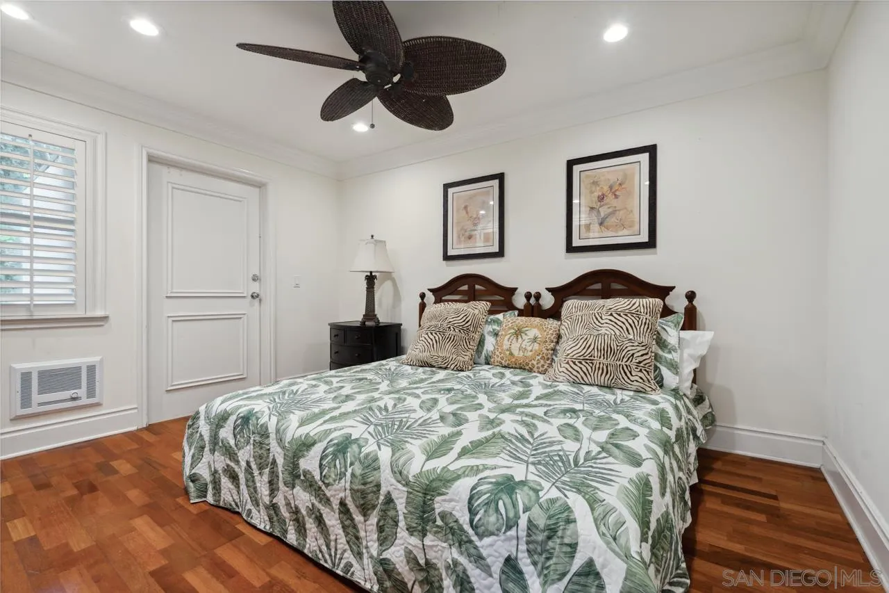 1219 Coast Boulevard, Unit 5 La Jolla, CA 92037 - Photo 26 of 31 a bedroom with a bed and a chandelier