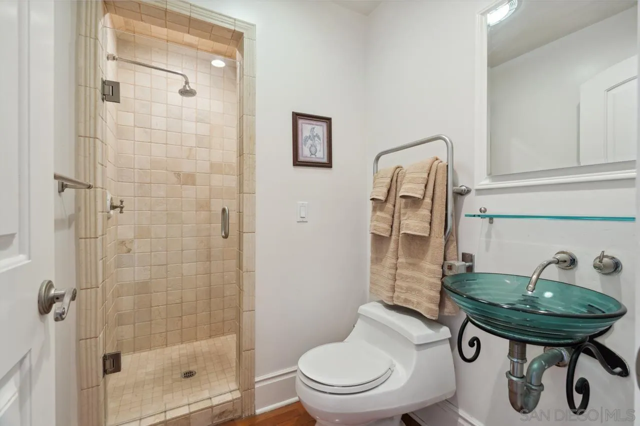 1219 Coast Boulevard, Unit 5 La Jolla, CA 92037 - Photo 27 of 31 a bathroom with a sink toilet and shower
