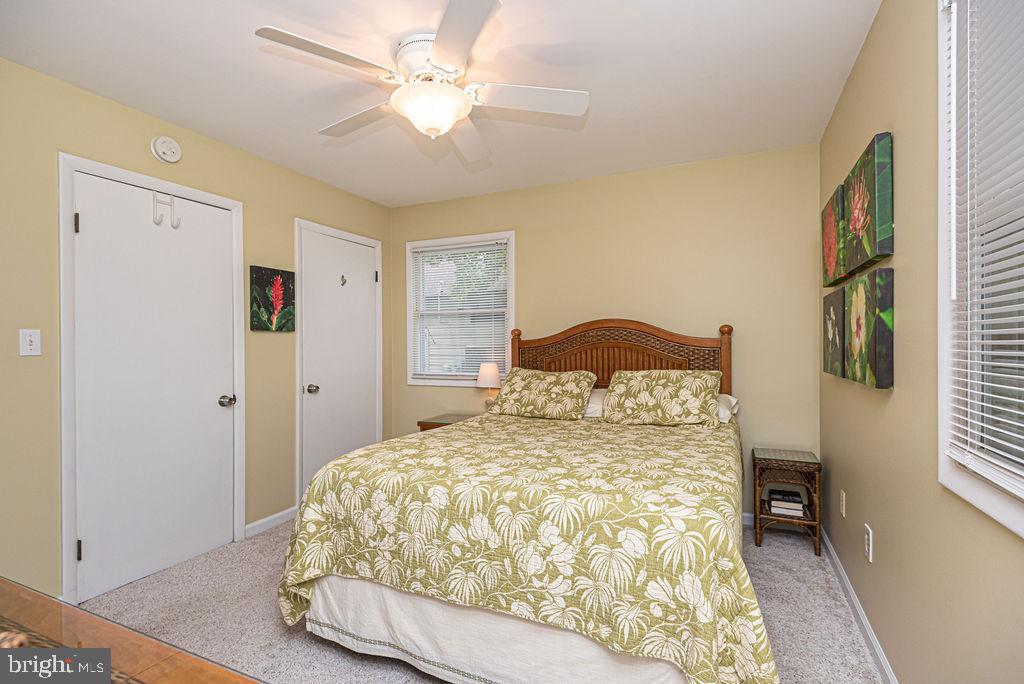 33 Falcon Bridge Road Ocean Pines, MD 21811 - Photo 46 of 71 a bedroom with a bed and a chandelier