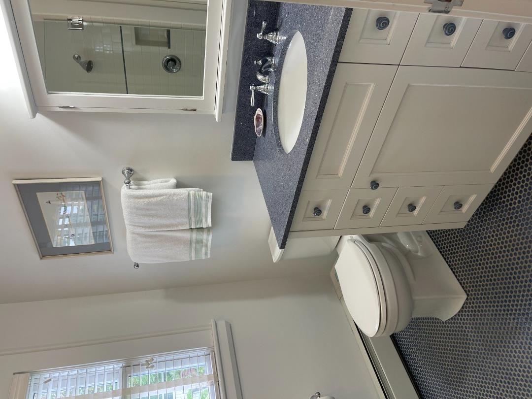 43 Cottage Street Edgartown, MA 02539 - Photo 18 of 24 a bathroom with a granite countertop toilet sink and mirror