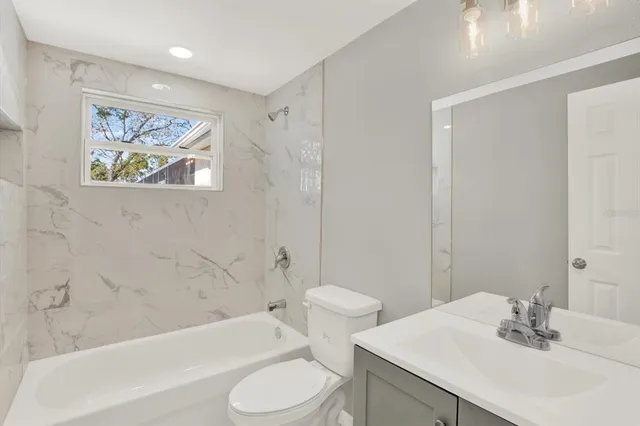 a bathroom with a sink a toilet and bathtub