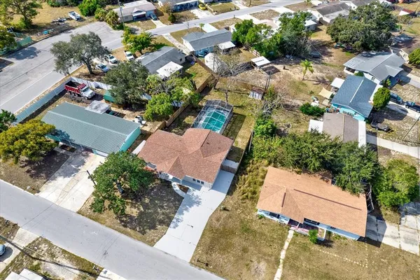 an aerial view of a house with a yard