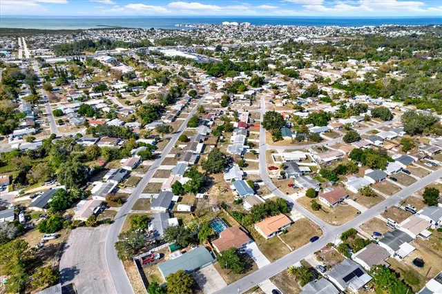 an aerial view of residential houses with city view