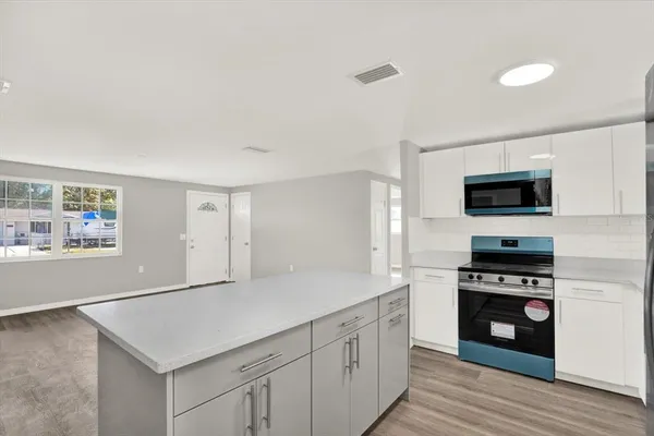 a kitchen with sink cabinets and stainless steel appliances