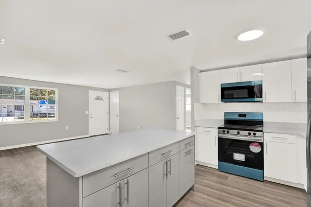 a kitchen with sink cabinets and stainless steel appliances