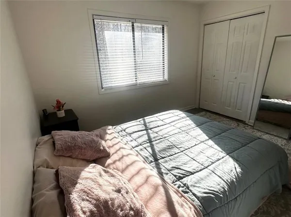 a bedroom with a bed and window
