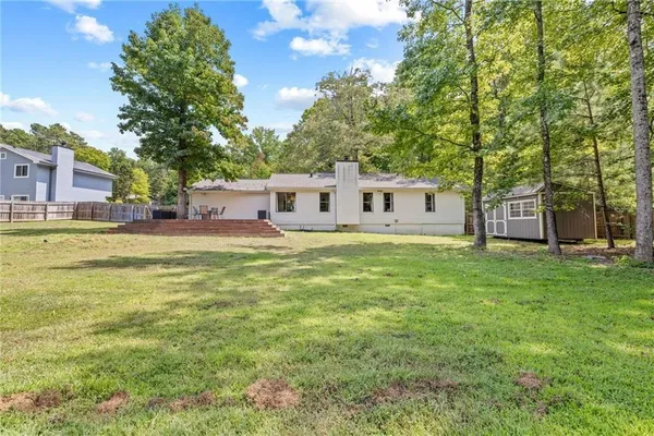 a house view with swimming pool in front of it